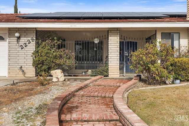 entrance to property featuring solar panels