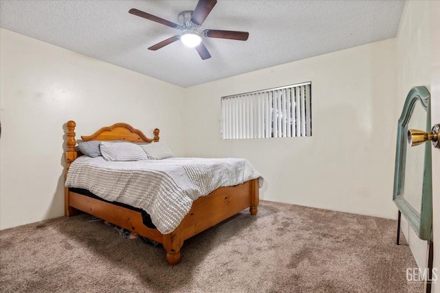 bedroom with ceiling fan, carpet floors, and a textured ceiling