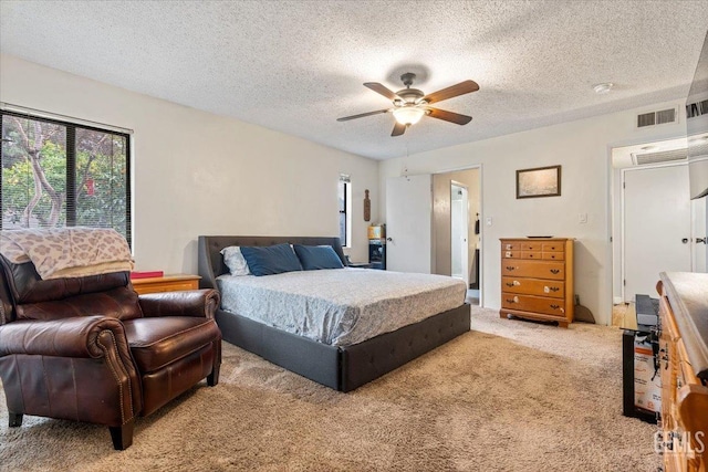 carpeted bedroom with a textured ceiling and ceiling fan