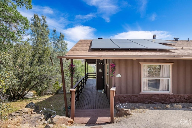 view of front of house with roof mounted solar panels