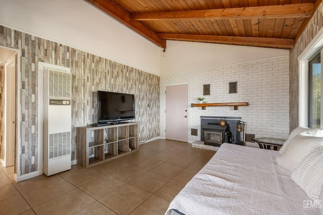 bedroom with a wood stove, tile patterned flooring, wooden ceiling, and a heating unit