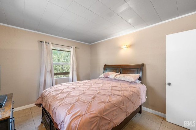 tiled bedroom featuring baseboards and ornamental molding