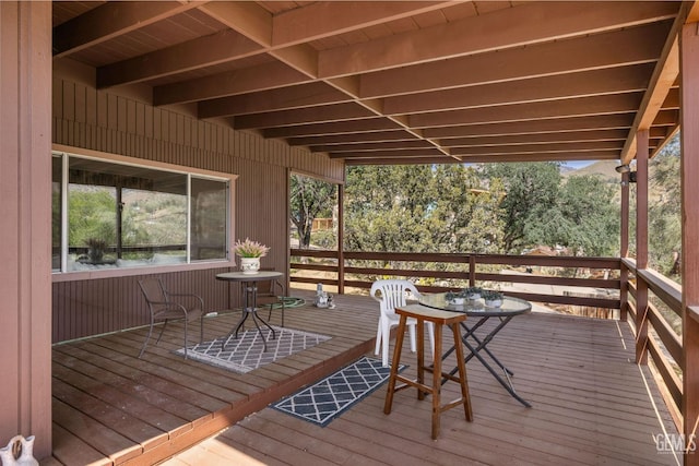 wooden terrace with outdoor dining area
