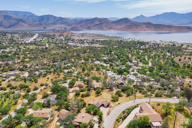 drone / aerial view featuring a water and mountain view