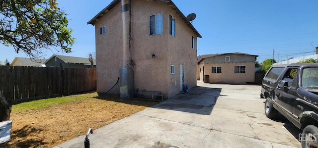 3871 W 109th St Unit 1, Inglewood, CA 90303 - back of property with stucco siding, driveway, and fence