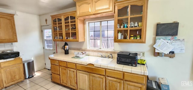 3871 W 109th St Unit 1, Inglewood, CA 90303 - kitchen featuring a sink, glass insert cabinets, tasteful backsplash, light tile patterned flooring, and tile counters