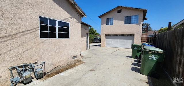 3871 W 109th St Unit 1, Inglewood, CA 90303 - view of side of home featuring a garage, stucco siding, driveway, and fence