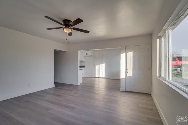 spare room featuring ceiling fan and dark wood-type flooring