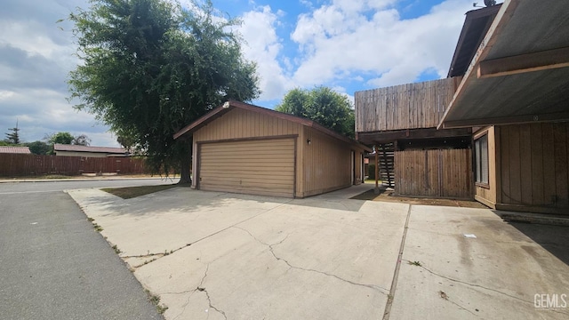 detached garage featuring fence