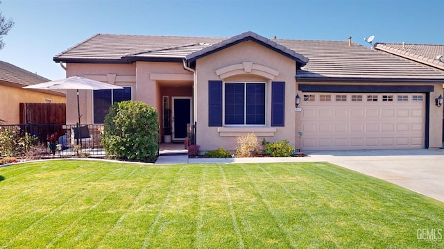 single story home with a garage and a front lawn