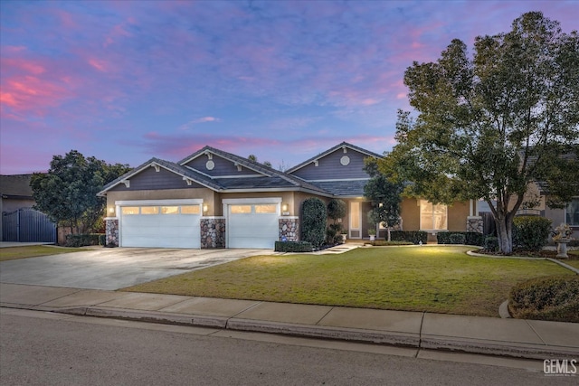 view of front of home with a yard and a garage