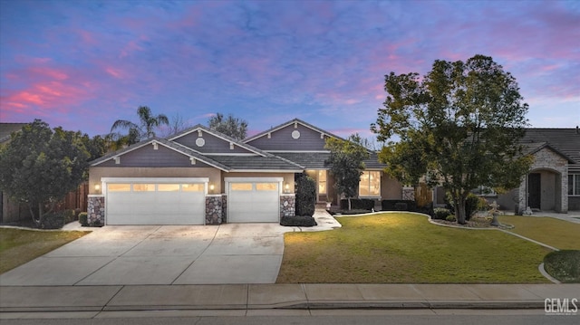 view of front of property featuring a lawn and a garage