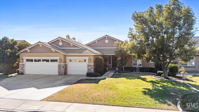 view of front of property with a garage and a front lawn