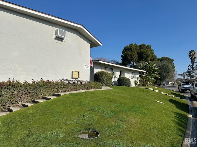 view of yard with a wall mounted air conditioner