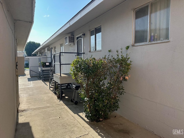 view of side of home with a wall mounted AC