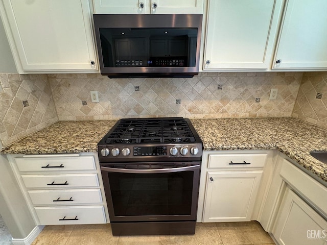 12301 Nacelle Ave, Bakersfield, CA 93312 - kitchen featuring stainless steel appliances, light tile patterned floors, light stone counters, and white cabinets