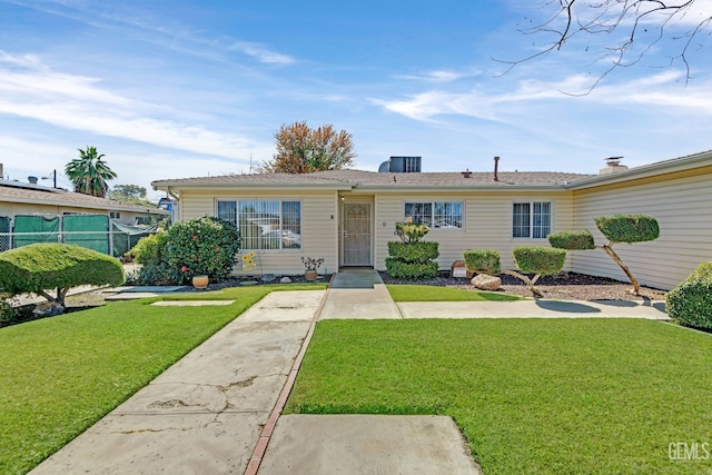 view of front facade with a front yard and fence