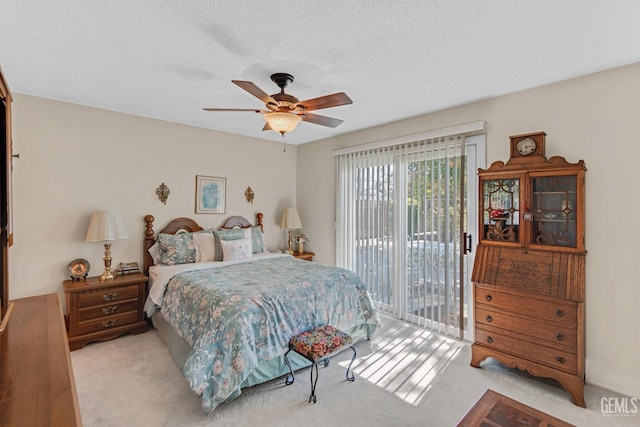 bedroom featuring a textured ceiling, carpet, a ceiling fan, and access to outside