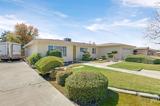 ranch-style house featuring a front yard and an attached garage