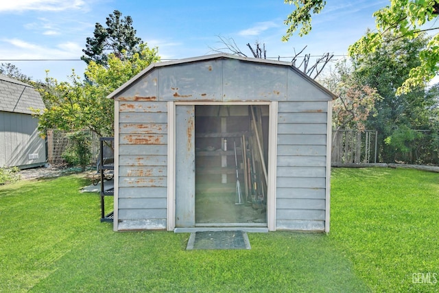 view of shed featuring fence