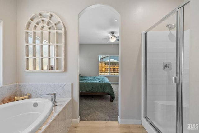 8610 Kowa St, Bakersfield, CA 93314 - ensuite bathroom featuring a stall shower, wood finished floors, a bath, and a ceiling fan