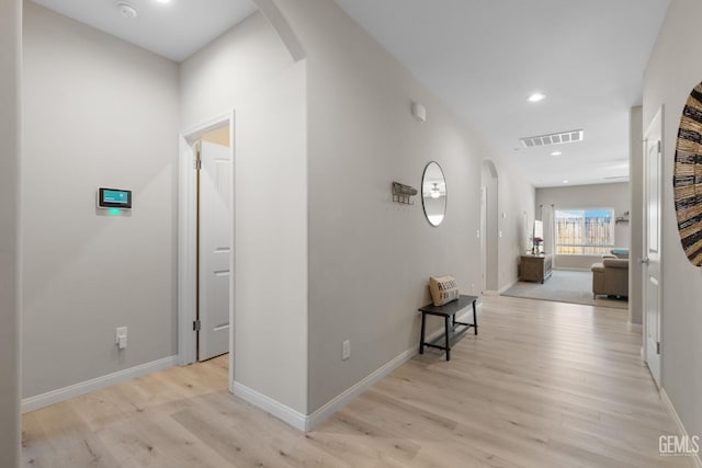 8610 Kowa St, Bakersfield, CA 93314 - hallway featuring arched walkways, light wood finished floors, and recessed lighting