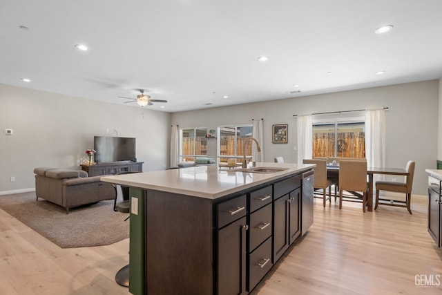 8610 Kowa St, Bakersfield, CA 93314 - kitchen featuring light wood-type flooring, ceiling fan, light countertops, recessed lighting, and a center island with sink