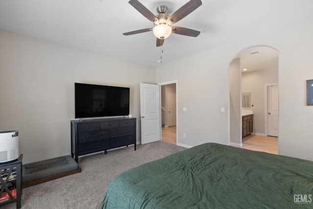 8610 Kowa St, Bakersfield, CA 93314 - carpeted bedroom featuring arched walkways, ensuite bathroom, and ceiling fan