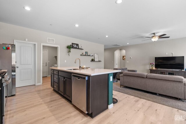 8610 Kowa St, Bakersfield, CA 93314 - kitchen featuring stainless steel appliances, arched walkways, light wood finished floors, a ceiling fan, and recessed lighting