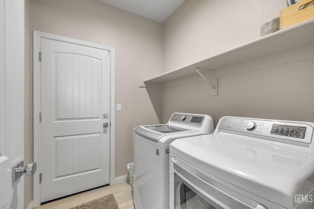 8610 Kowa St, Bakersfield, CA 93314 - laundry area featuring washer and clothes dryer and light wood-type flooring