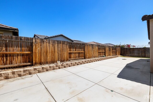 8610 Kowa St, Bakersfield, CA 93314 - fenced backyard with a patio area