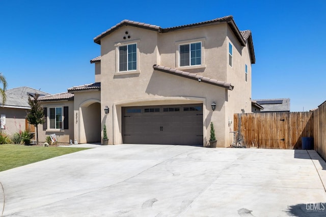 8610 Kowa St, Bakersfield, CA 93314 - mediterranean / spanish home featuring a tiled roof, a garage, stucco siding, and driveway