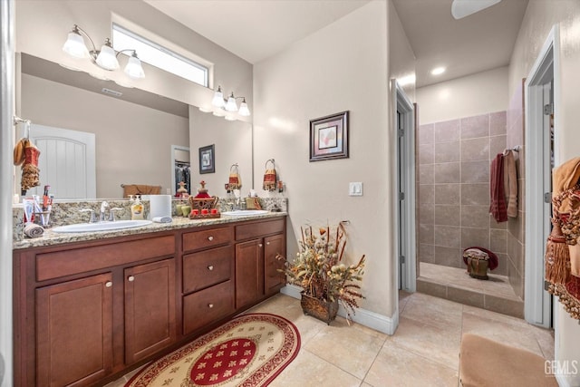 full bathroom featuring tile patterned floors, double vanity, and baseboards