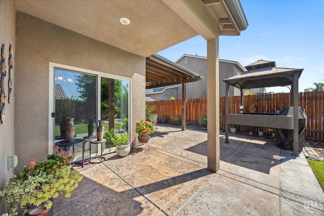 view of patio featuring a gazebo and a fenced backyard