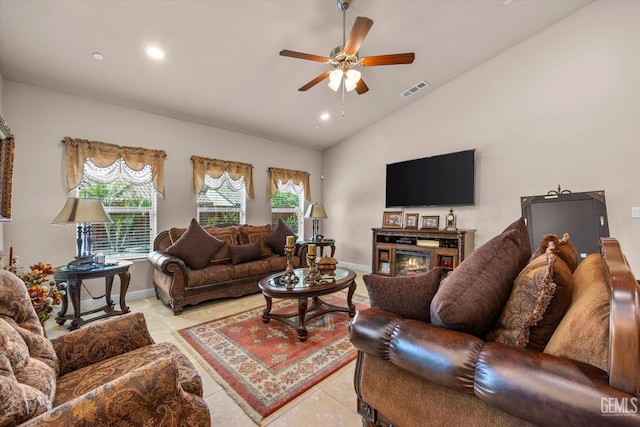 living room featuring vaulted ceiling, a ceiling fan, recessed lighting, baseboards, and a glass covered fireplace