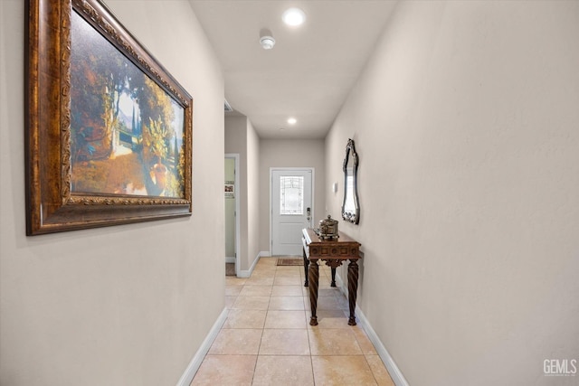 hallway with baseboards, light tile patterned flooring, and recessed lighting