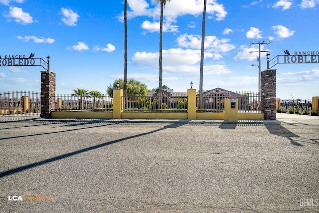 view of street with a gated entry and a gate