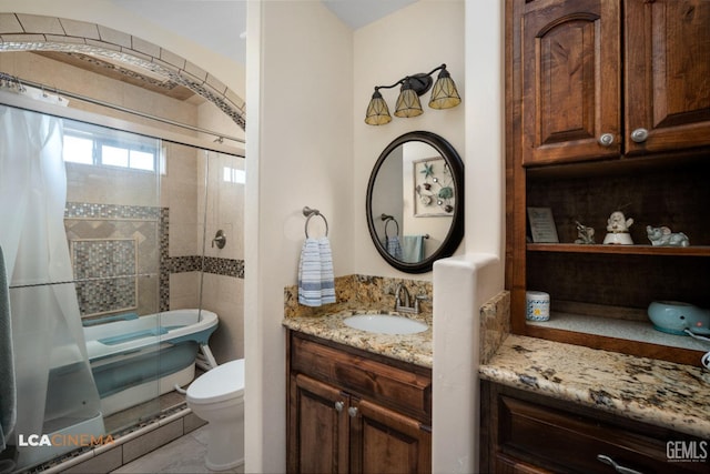 bathroom with toilet, a freestanding bath, a shower, and vanity