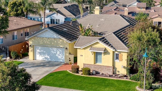 view of front of home with a front yard and a garage