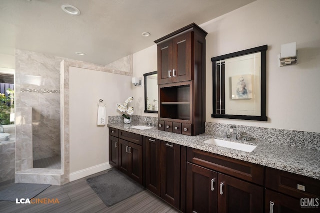 bathroom with vanity and tiled shower