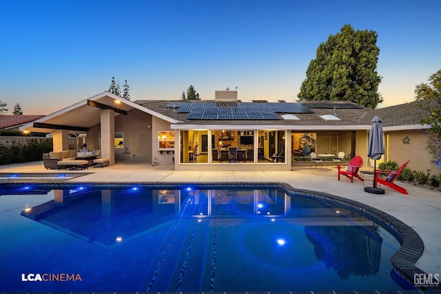 pool with an outdoor living space and a patio