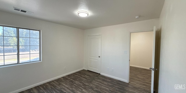 8808 Cape Flattery Dr, Bakersfield, CA 93312 - unfurnished bedroom with dark wood-style floors, multiple windows, and a closet