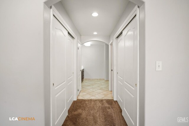 3400 Tori Lorene Ave, Bakersfield, CA 93313 - hallway with arched walkways, recessed lighting, light colored carpet, and light tile patterned flooring