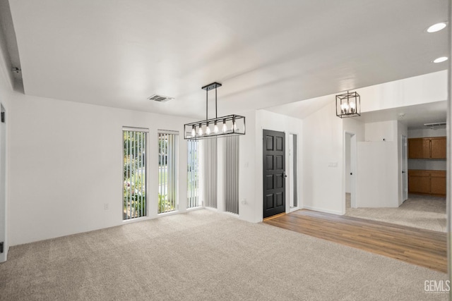 7108 Luke Ave, Bakersfield, CA 93308 - unfurnished room featuring light colored carpet, a chandelier, and recessed lighting