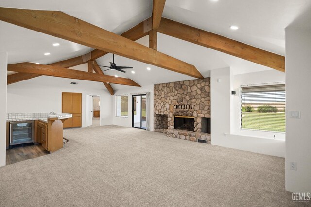 7108 Luke Ave, Bakersfield, CA 93308 - unfurnished living room featuring beverage cooler, carpet, a fireplace, healthy amount of natural light, and recessed lighting
