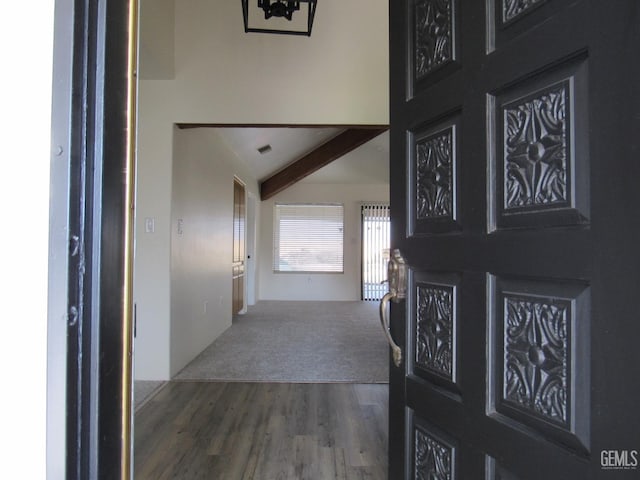 foyer featuring dark hardwood / wood-style flooring and lofted ceiling with beams