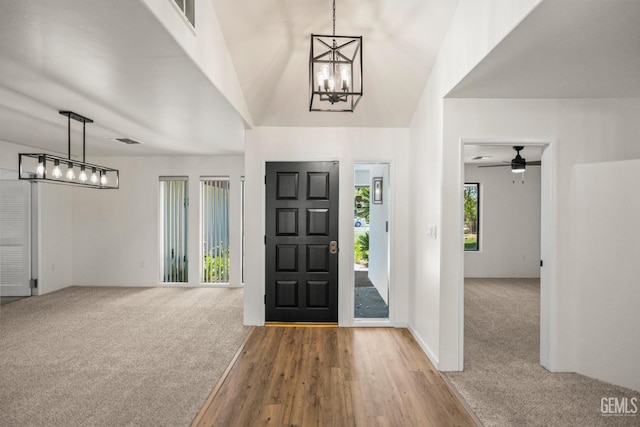 7108 Luke Ave, Bakersfield, CA 93308 - entrance foyer featuring a chandelier, carpet floors, ceiling fan, and wood finished floors