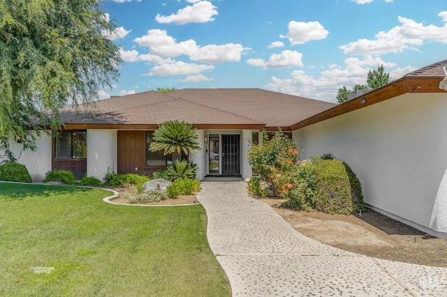 7108 Luke Ave, Bakersfield, CA 93308 - view of front of home with a front lawn, stucco siding, and roof with shingles
