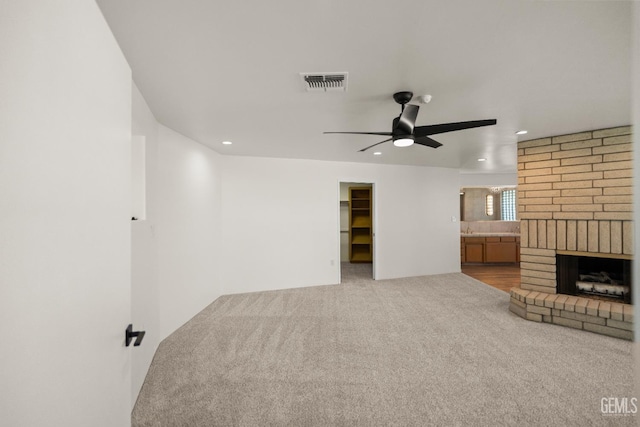 7108 Luke Ave, Bakersfield, CA 93308 - unfurnished living room with a ceiling fan, recessed lighting, carpet floors, and a brick fireplace