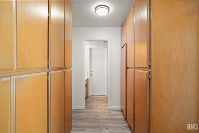 7108 Luke Ave, Bakersfield, CA 93308 - hallway featuring light wood-style floors and baseboards
